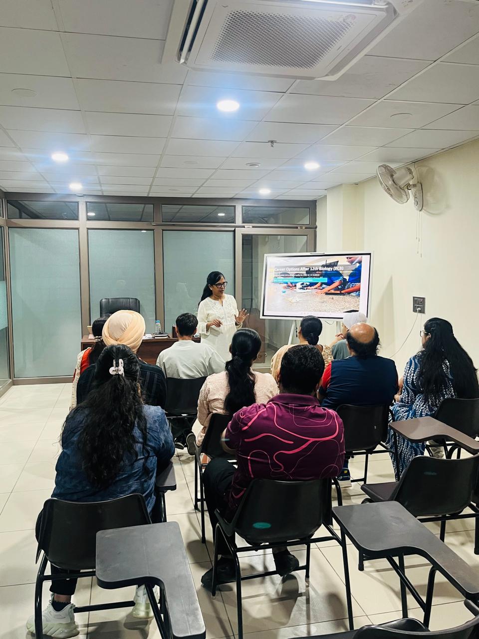 Rekha presenting career options after Class 12 to students and parents